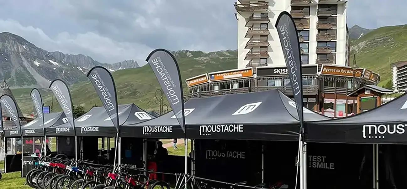 Banner Flag with Tents on top of the Canopy
