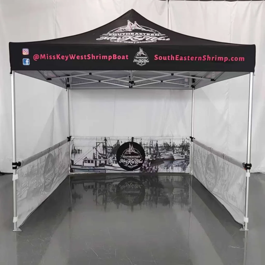 A professional heavy duty pop up tent for business branded with a company logo at an outdoor trade fair.